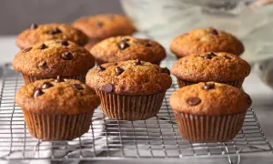 Muffins banane chocolat dorés et moelleux, parsemés de pépites de chocolat, refroidissant sur une grille.