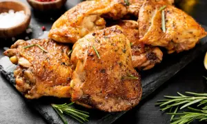 Cuisses de poulet dorées et croustillantes, assaisonnées d'herbes, prêtes à être dégustées. Un délice cuisiné au Cookeo.