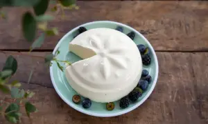Un blanc-manger crémeux, décoré de baies, évoque la vraie recette du blanc-manger.