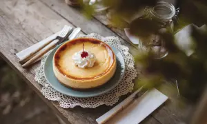 Un délicieux cheesecake, prêt à être dégusté, avec une cerise sur le dessus. Une invitation à essayer cette recette !