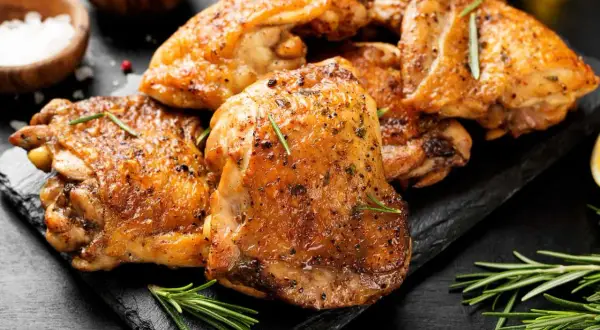 Cuisses de poulet dorées et croustillantes, assaisonnées d'herbes, prêtes à être dégustées. Un délice cuisiné au Cookeo.