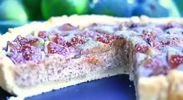 Une délicieuse tarte aux figues, avec sa pâte dorée et sa garniture généreuse de fruits violets et rouges.