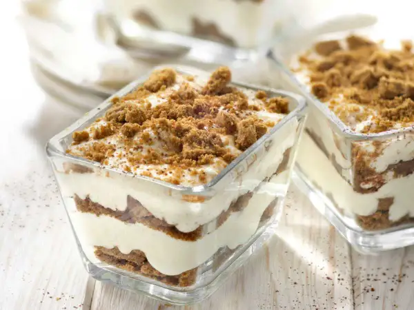 Délicieux tiramisu speculoos en verrines, superposant crème onctueuse et biscuits émiettés, le tout saupoudré de miettes croustillantes.