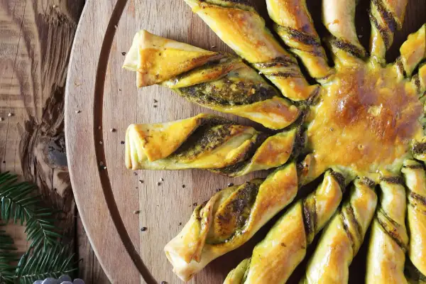 Tarte soleil dorée, garnie d'une farce verte, prête à être dégustée.